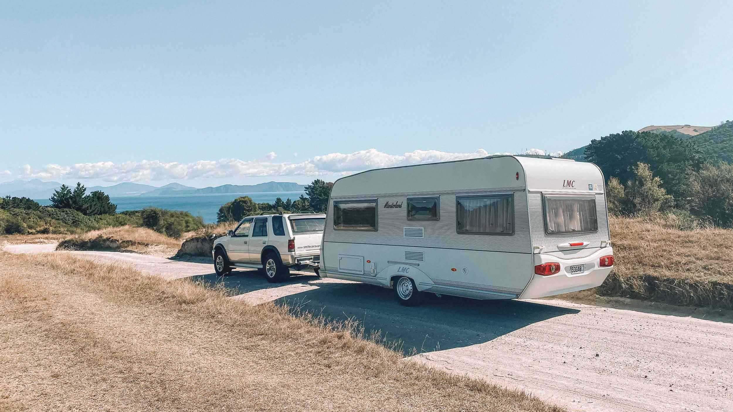 Caravan being towed down gravel road to beautiful NZ beach - Smile Caravans Hawkes Bay