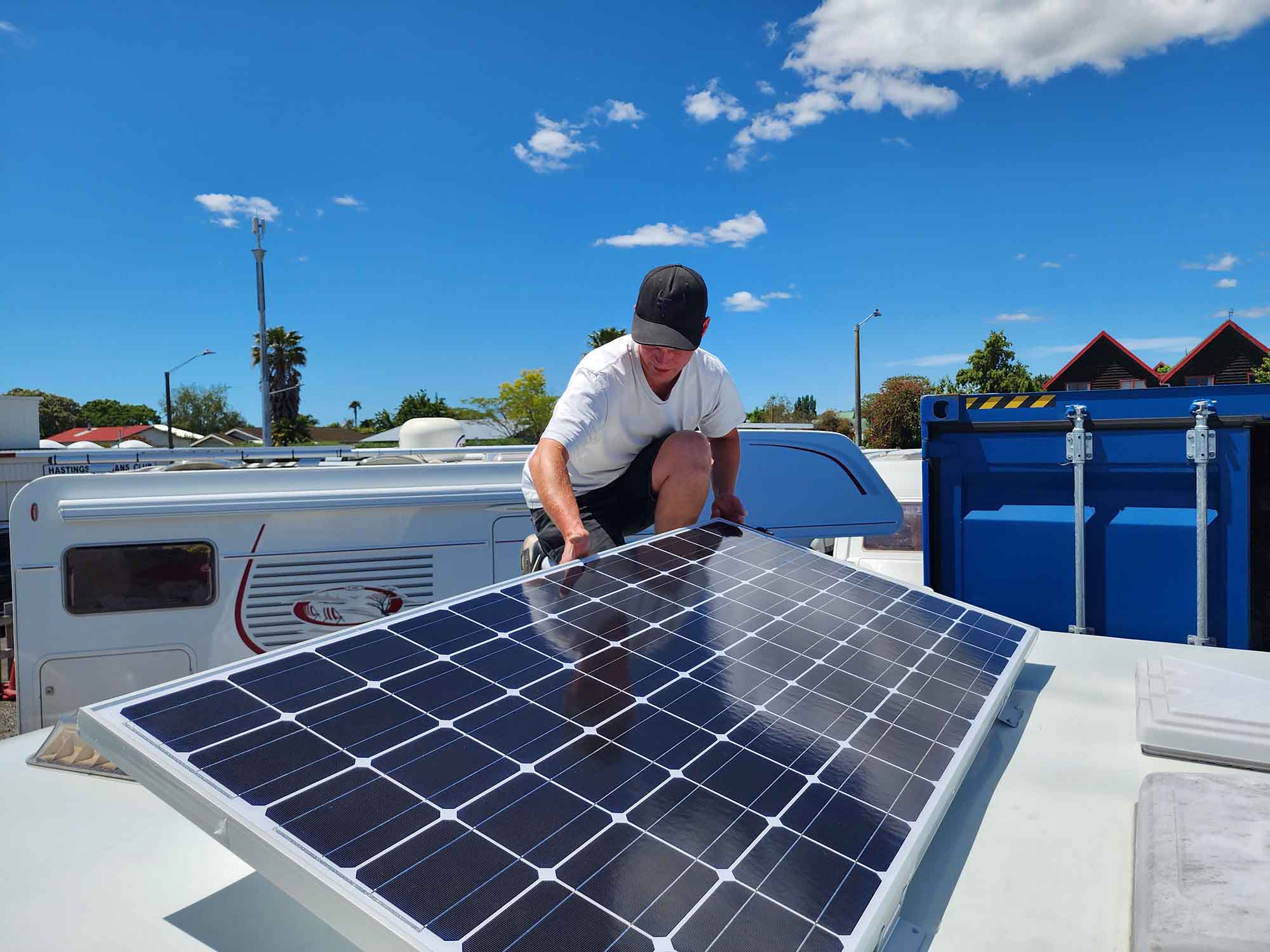 Andre from Smile Caravans installing a solar panel on caravan roof in Hawkes Bay