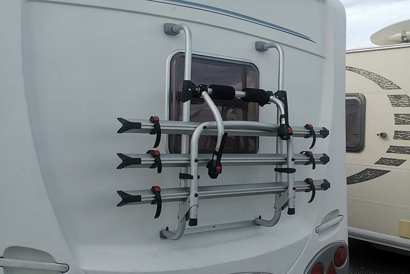 Bike racks on back of caravan parked in Smile Caravans shop